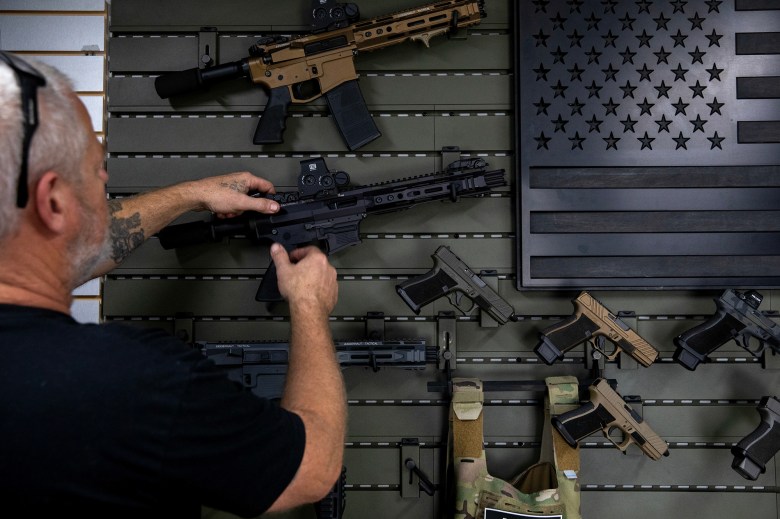 Gunsmith Don Gregory shows off two new single action firearms recently released by Juggernaut Tactical in Orange on Sept. 21, 2023. Photo by Alisha Jucevic for CalMatters