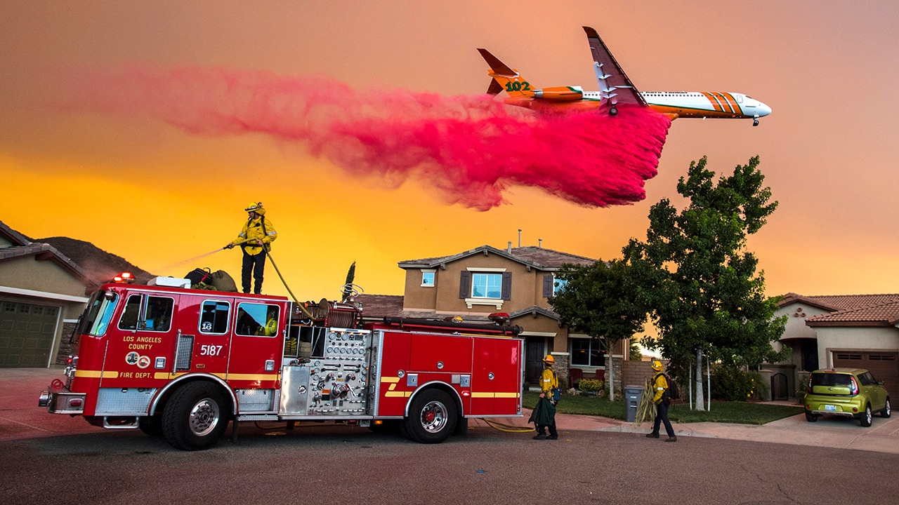 Photo of a plane dropping fire retardant