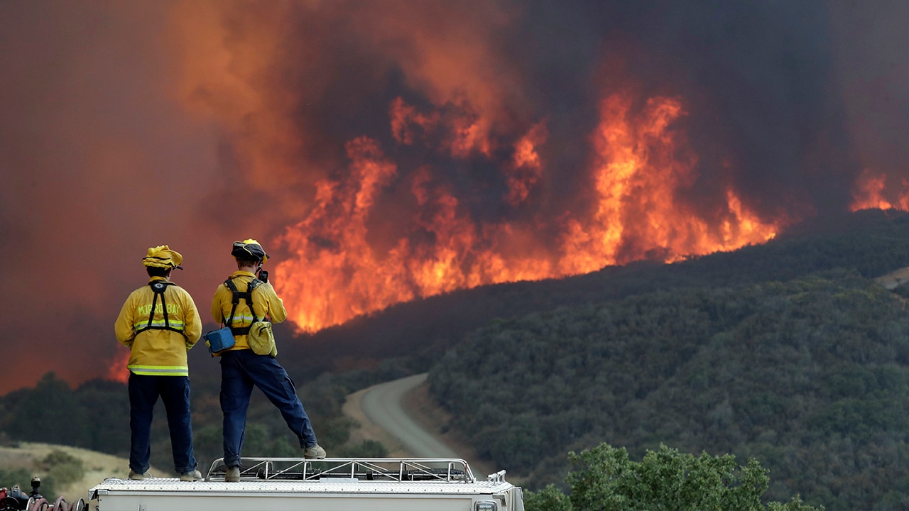 Photo of a fire crew keeping an eye on an advancing wildfire in SLO
