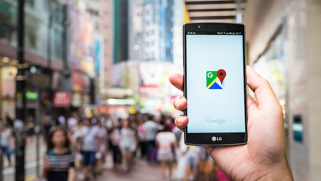Stock photo of someone holding a smartphone, using google maps
