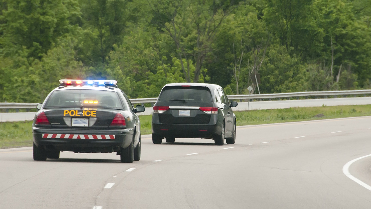 Stock photo of police car going after another car