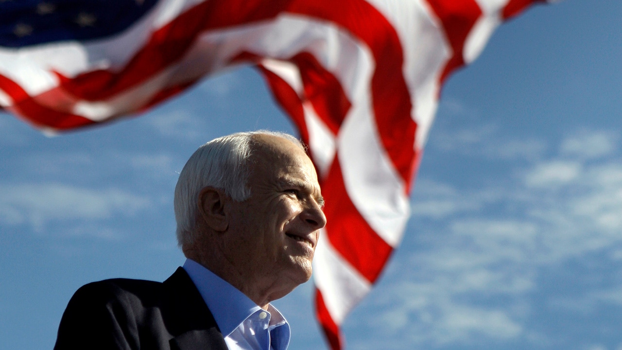 Photo of John McCain in front of an American flag