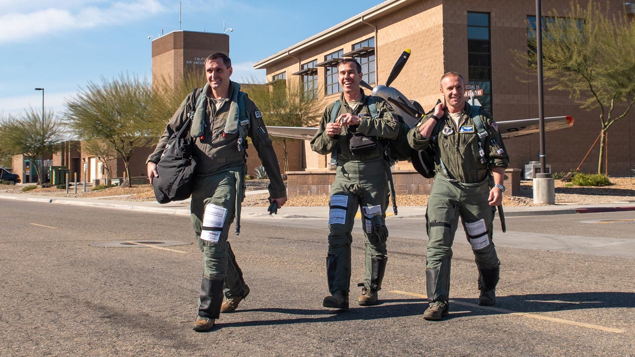 Pilots assigned to 144th Fighter Wing walk to their jets.
