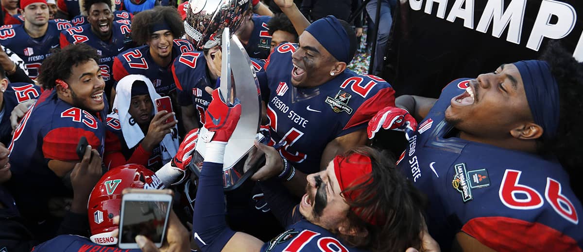 Photo of Fresno State football team celebrating after their win