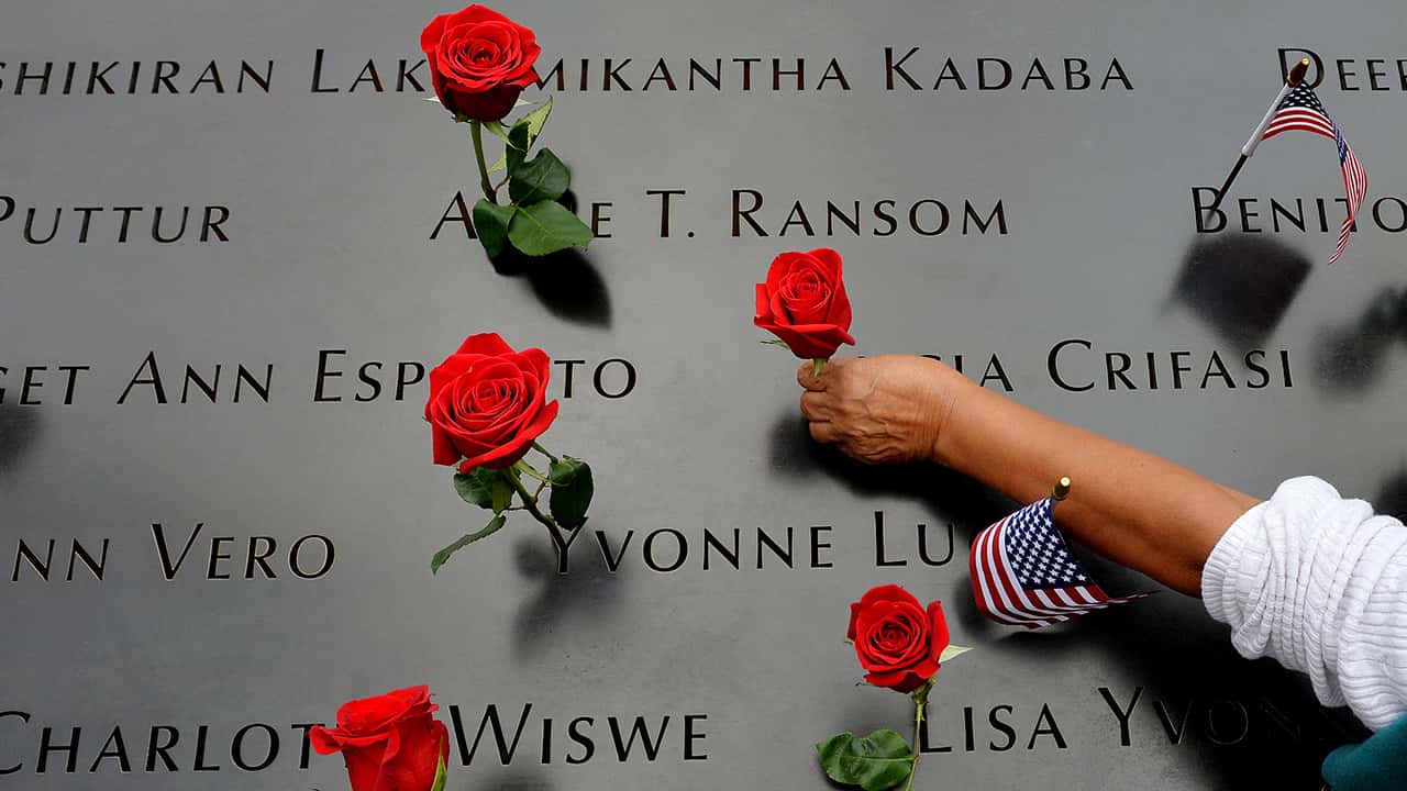 Photo of the names of 9/11 victims and roses