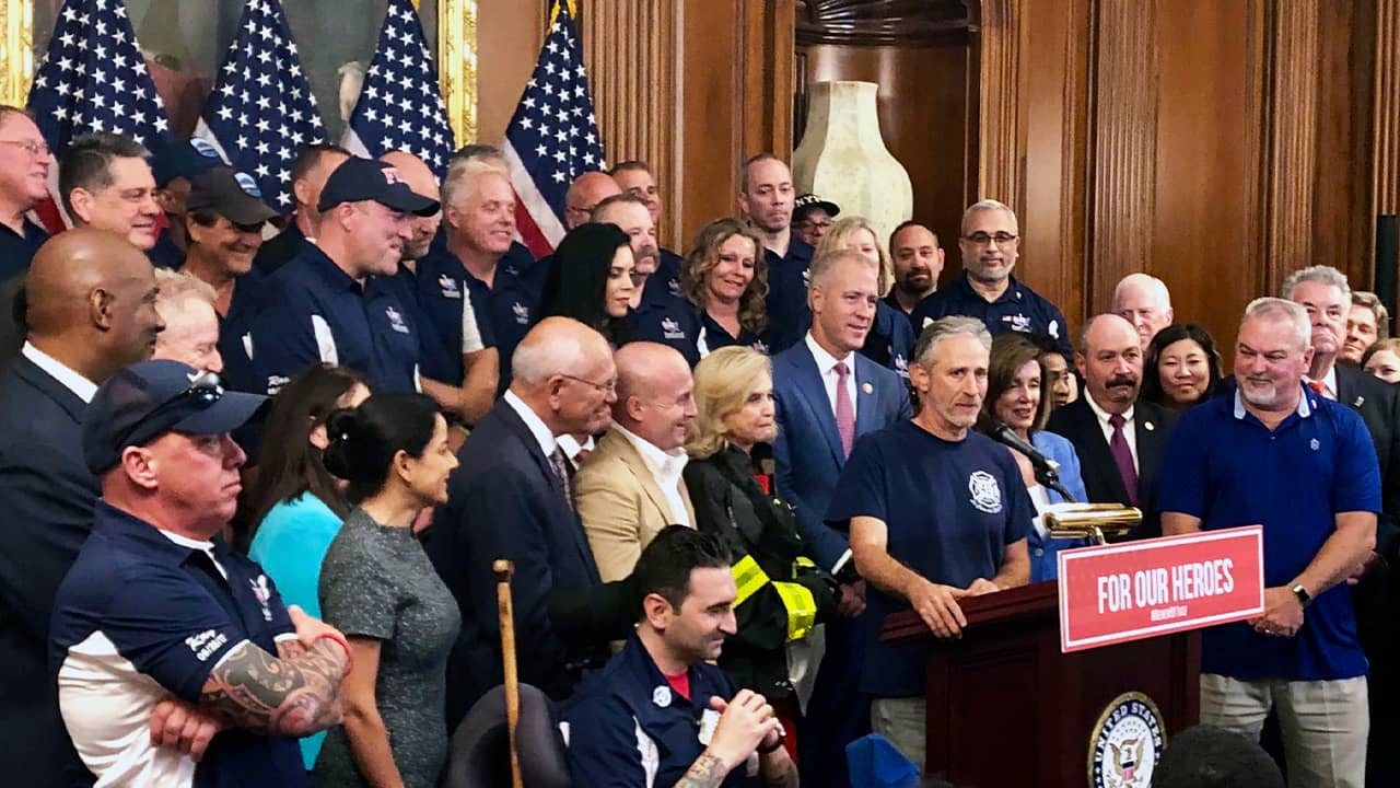 Photo of Jon Stewart speaking at a news conference on behalf of 9/11 victims
