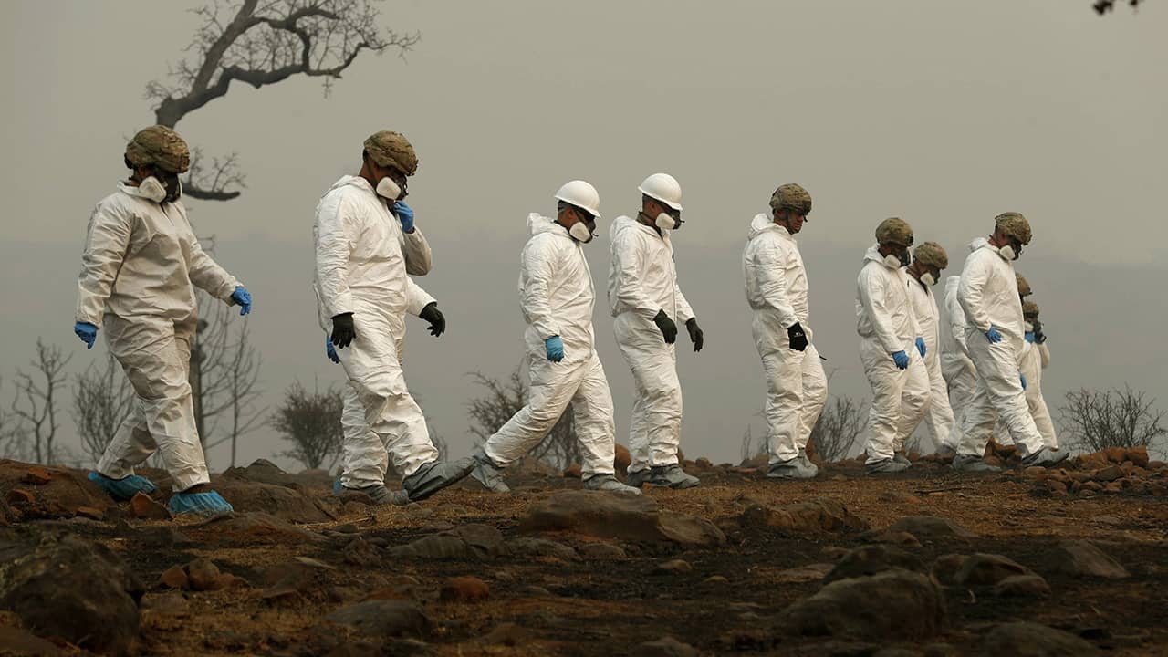 National Guard troops search for human remains from California's Paradise wildfire.