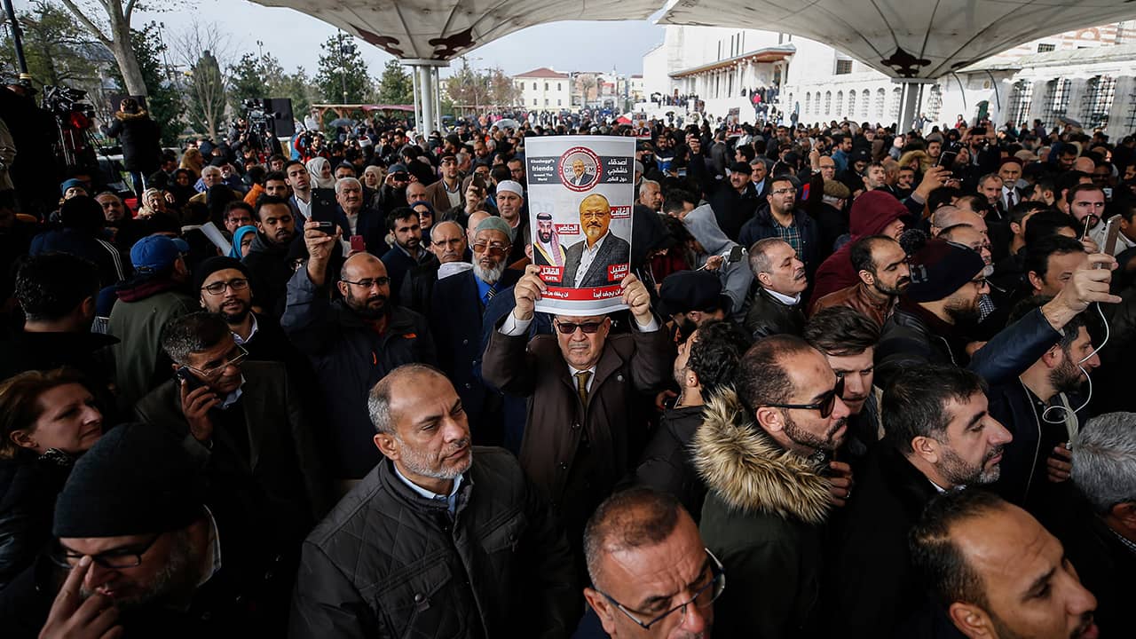 Photo of man holding a poster