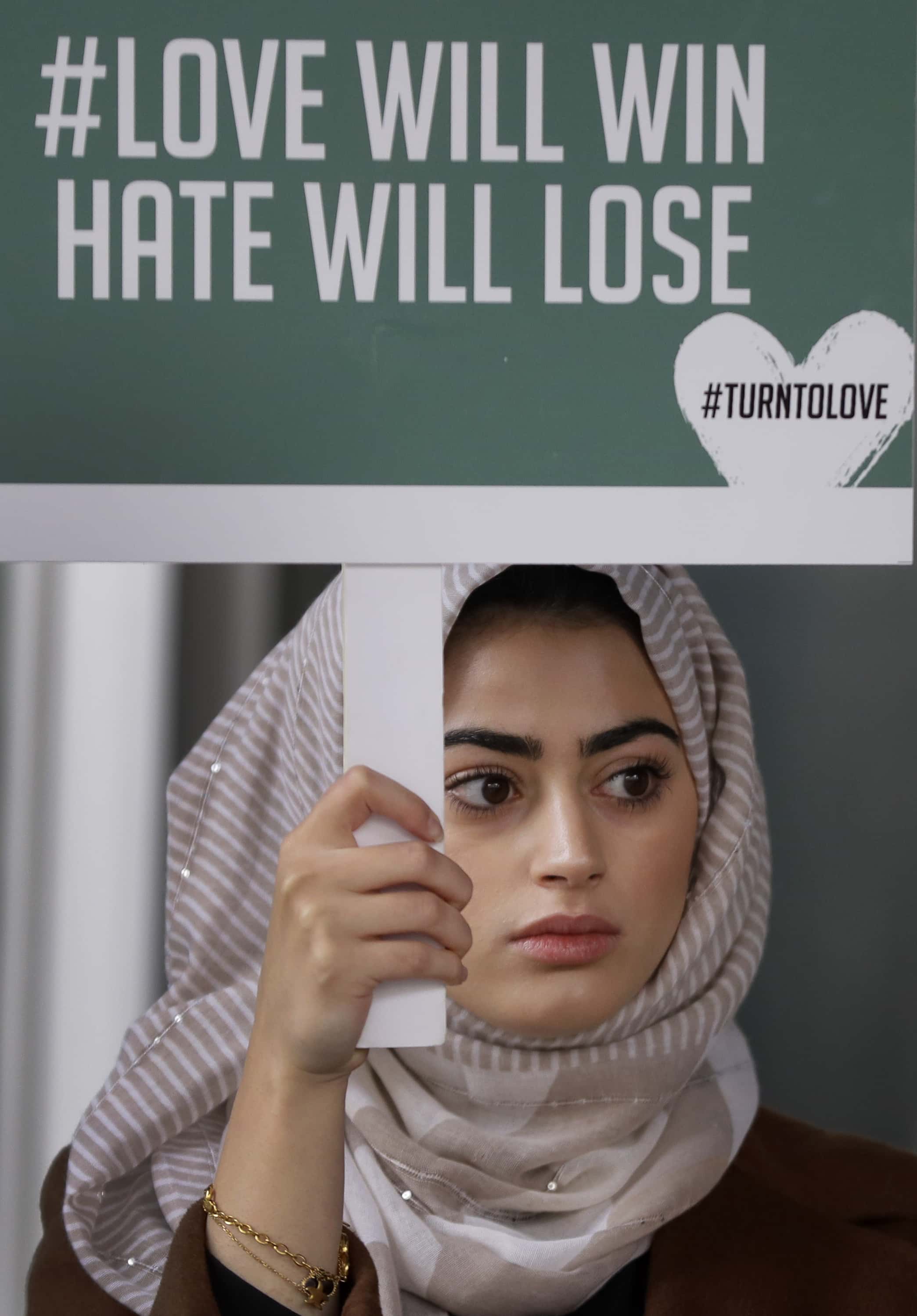 Photo of woman at a London vigil for mosque attack in New Zealand