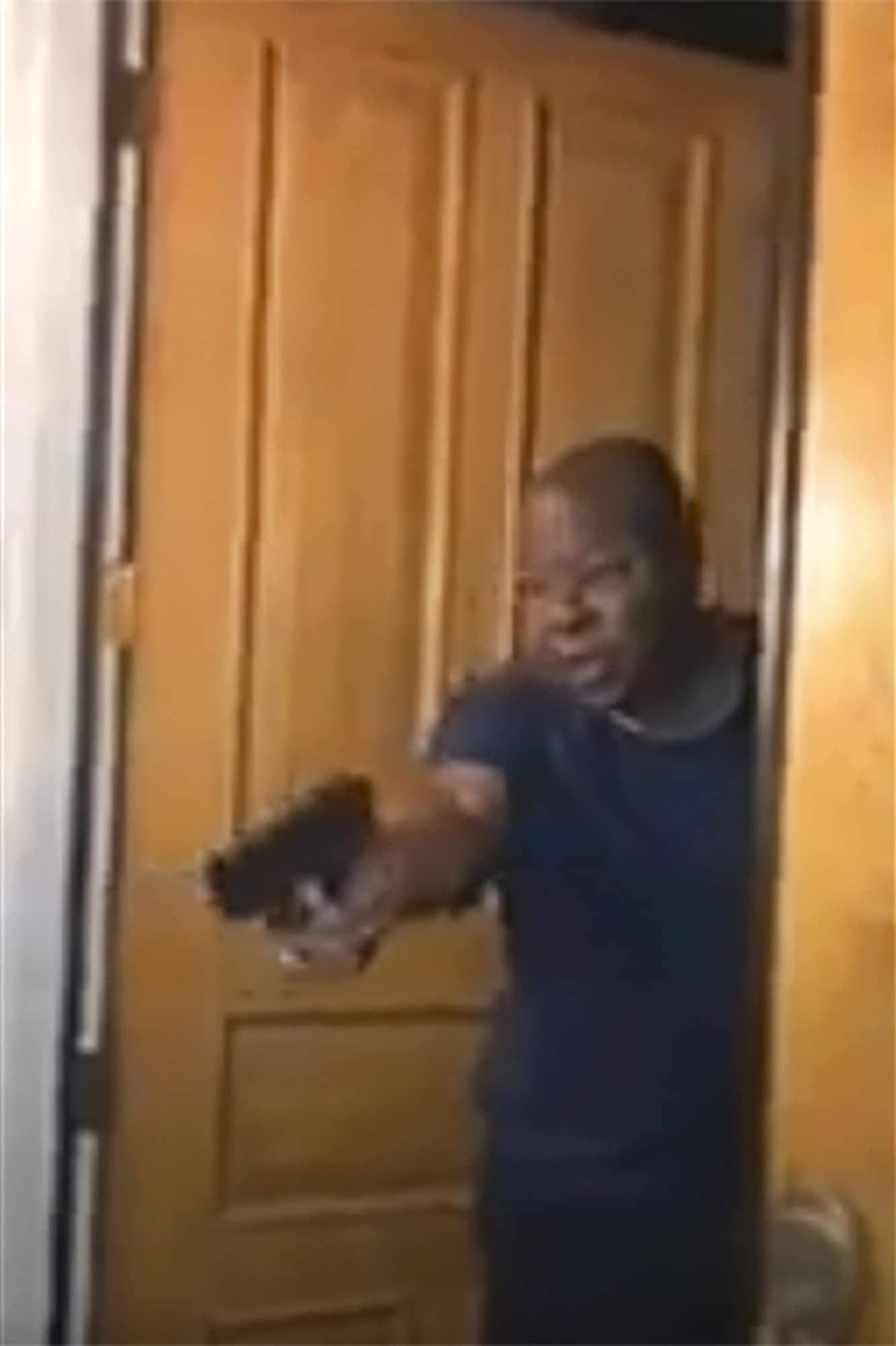 Photo of Los Angeles County District Attorney Jackie Lacey's husband David Lacey pointing a gun at Black Lives Matter protesters outside their home in the Granada Hills section of LA