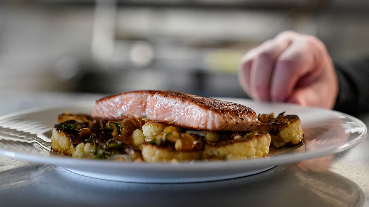 A farm-raised salmon dish at Scoma's can be seen before being served to a customer in San Francisco, Monday, March 20, 2023.