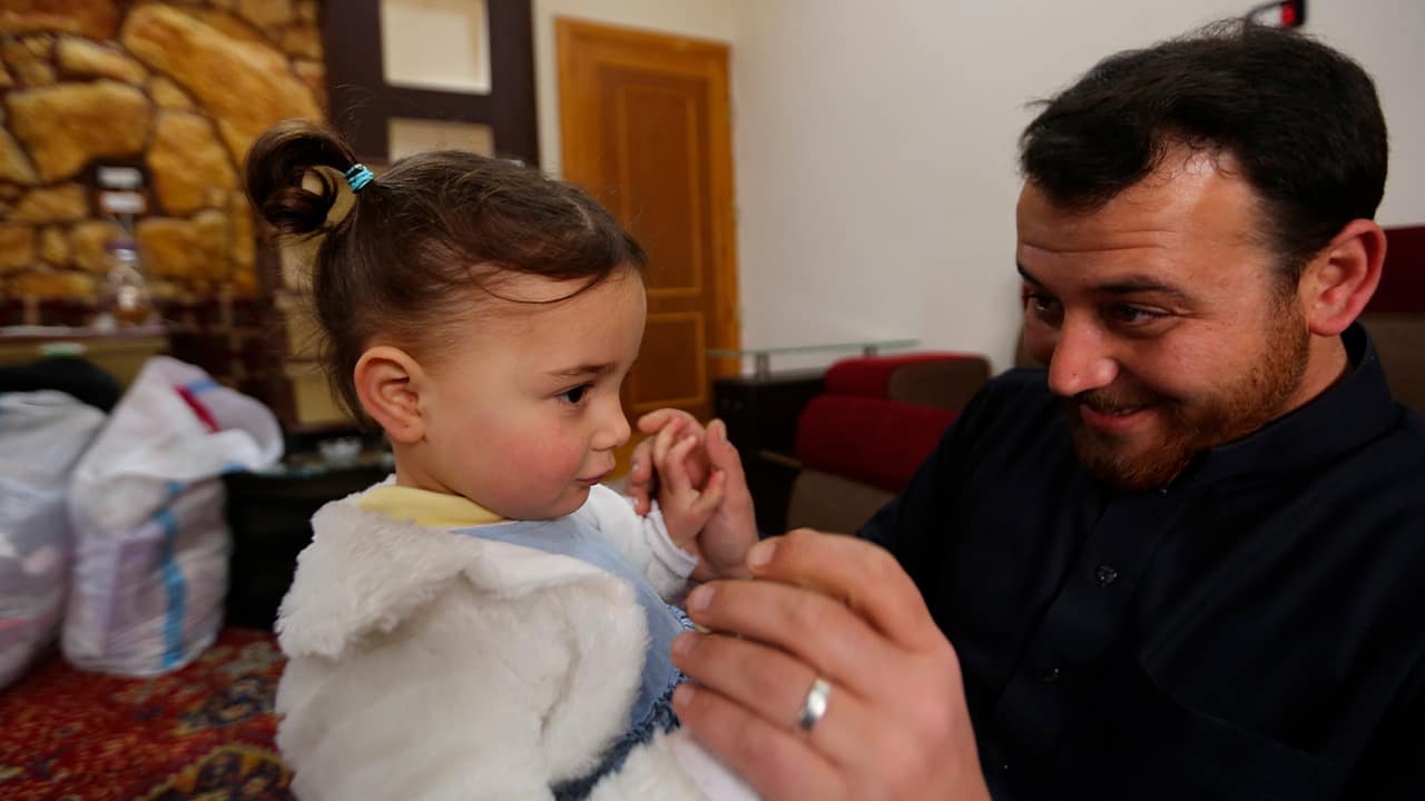 Photo of Abdullah Mohammed with his daughter, three-year-old Salwa inside a house he recently fled to, near the Syrian-Turkish border, in Sarmada, Syria