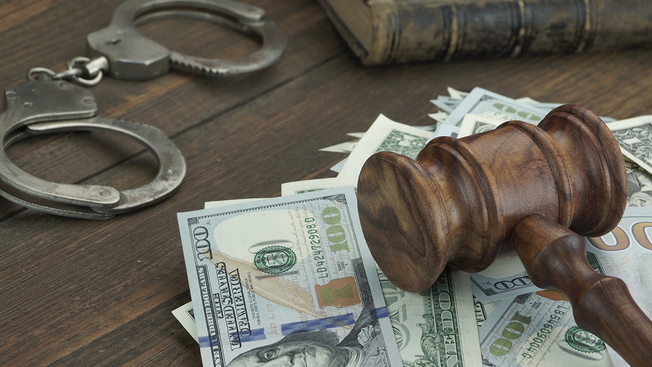 Stock photo of money, gavel, and handcuffs