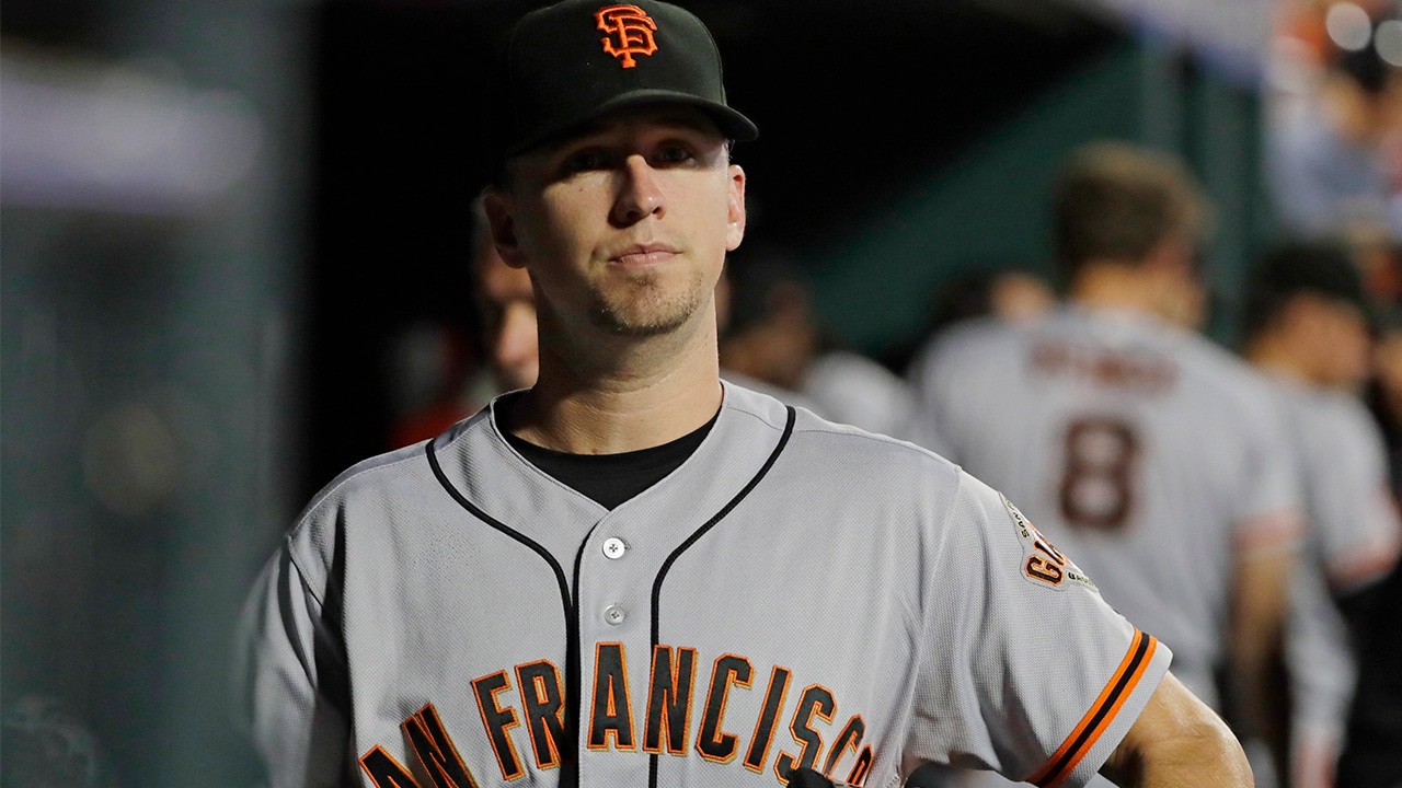 Photo of San Francisco Giants' Buster Posey walking in the dugout