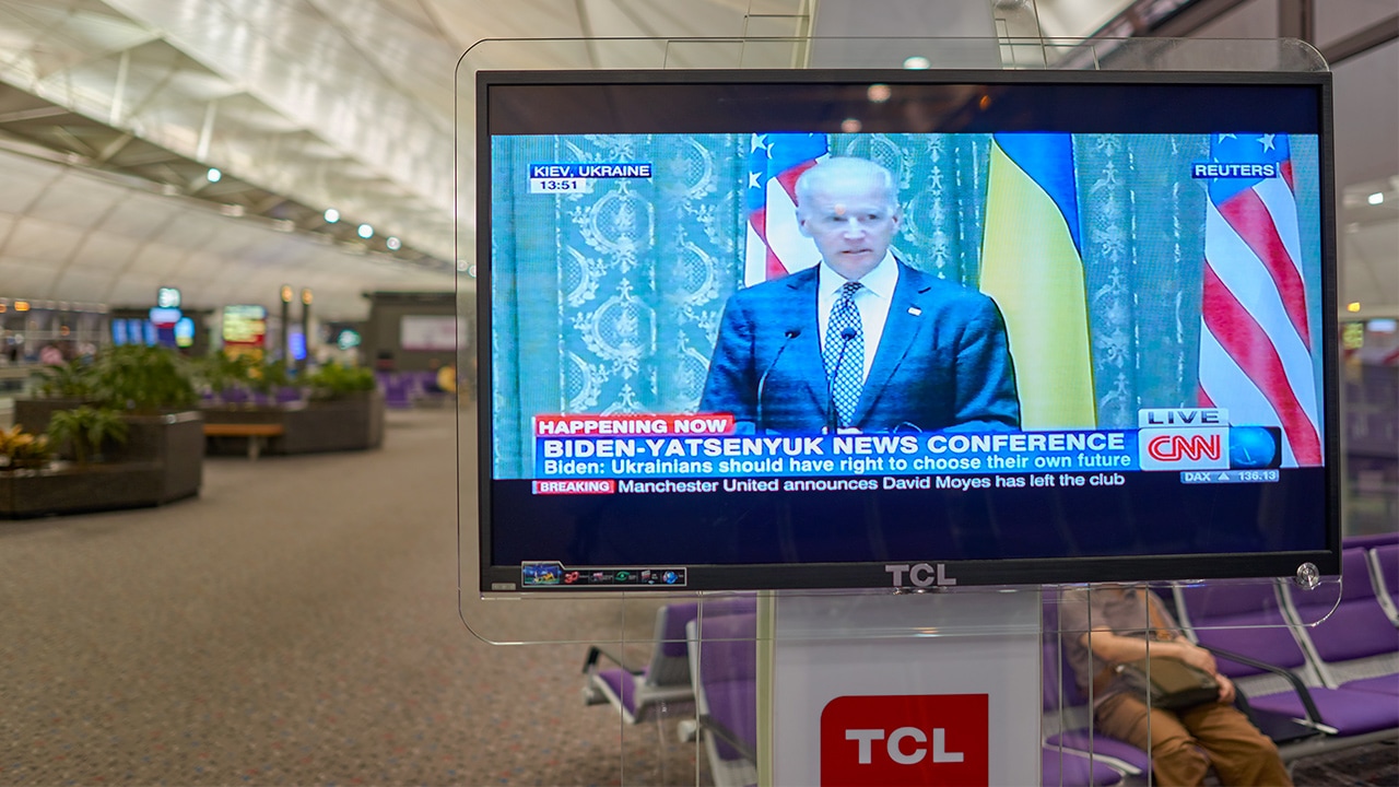 Photo of an airport TV airing CNN News