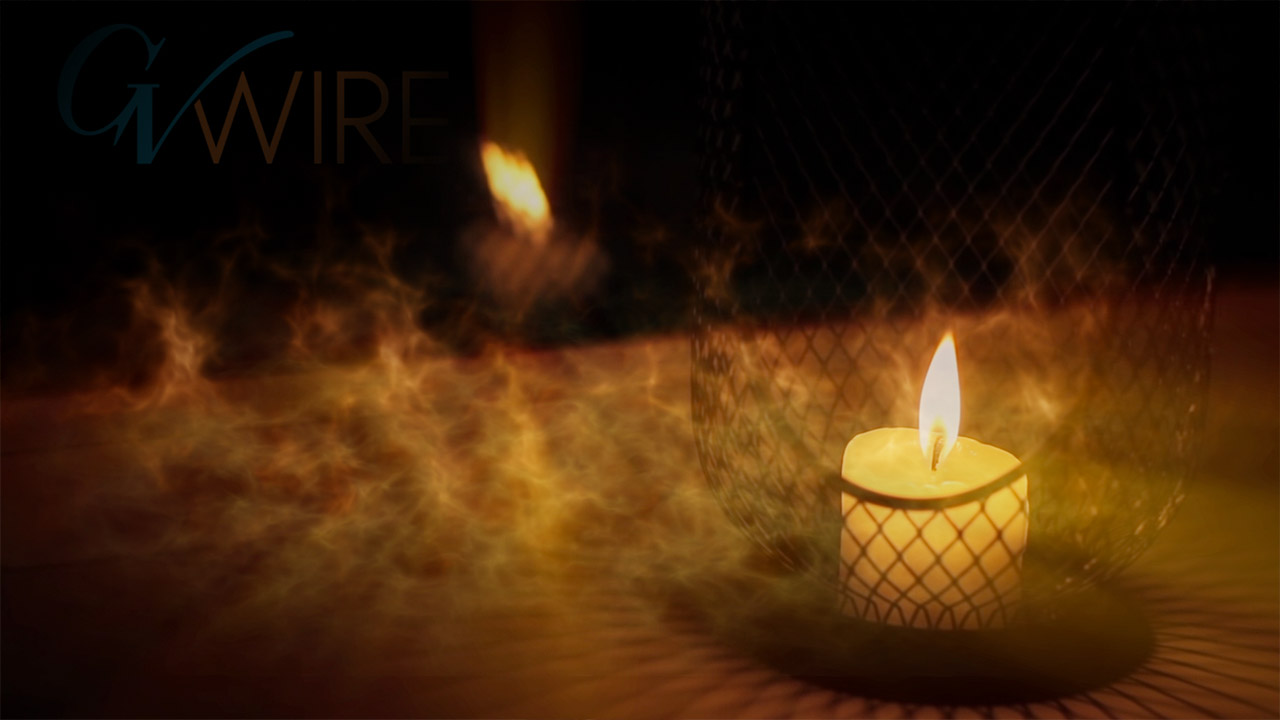 photo of a candle burning at night outside