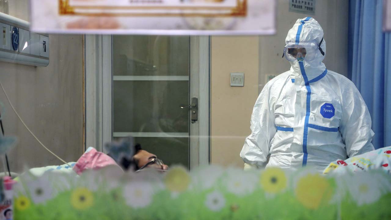 Photo of a doctor with to a patient in an isolation ward at a hospital in Wuhan in central China's Hubei Province