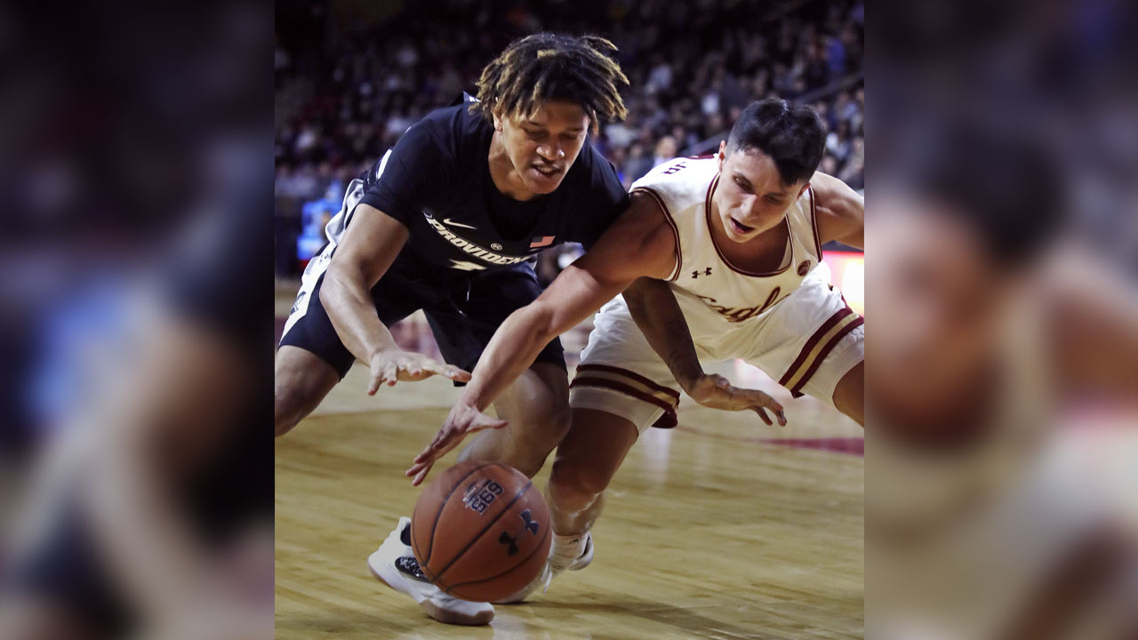 Photo of Chris Herren Jr. diving for a loose ball.