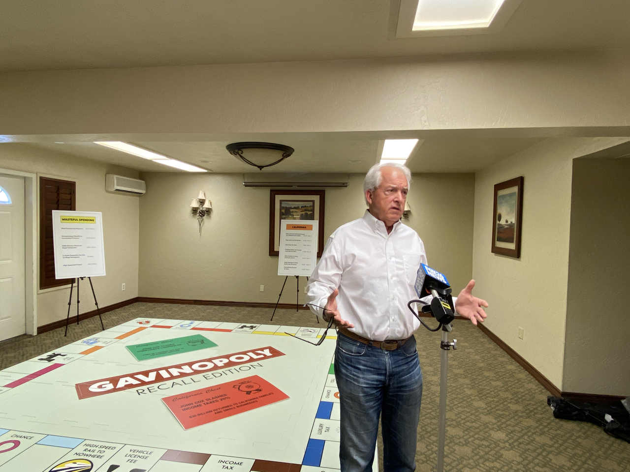 John Cox displayed his giant 'Gavinopoly" board at a stop in Fresno on Friday. (GV Wire/David Taub)