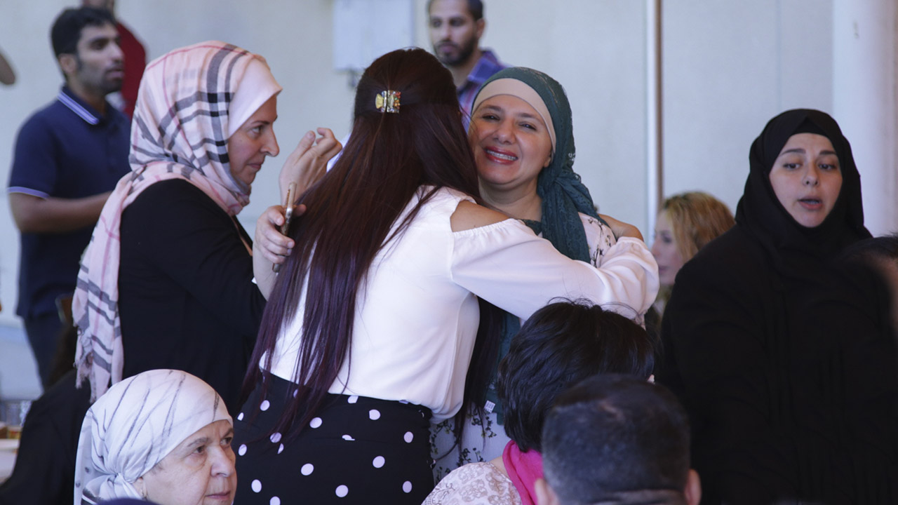 Photo of Muslims hugging at the end of the Ramadan Fast in Fresno, CA.
