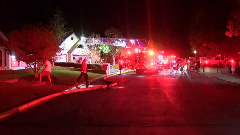 Photo of firefighters at burned house
