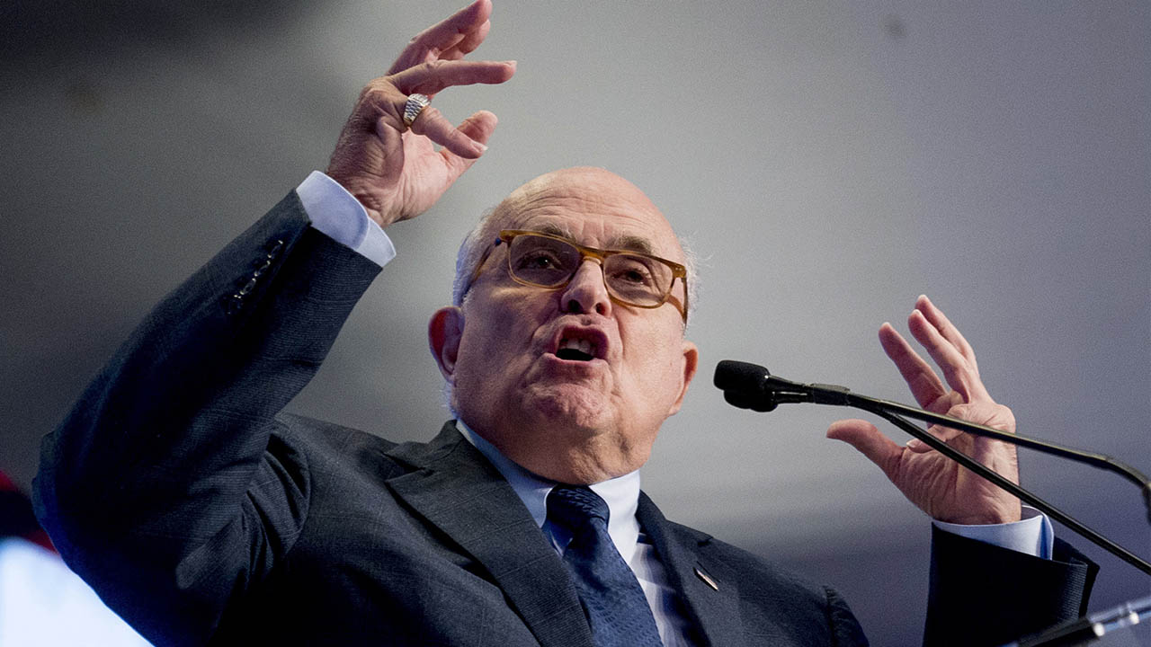 Photo of Rudy Giuliani speaking and making a point with both hands