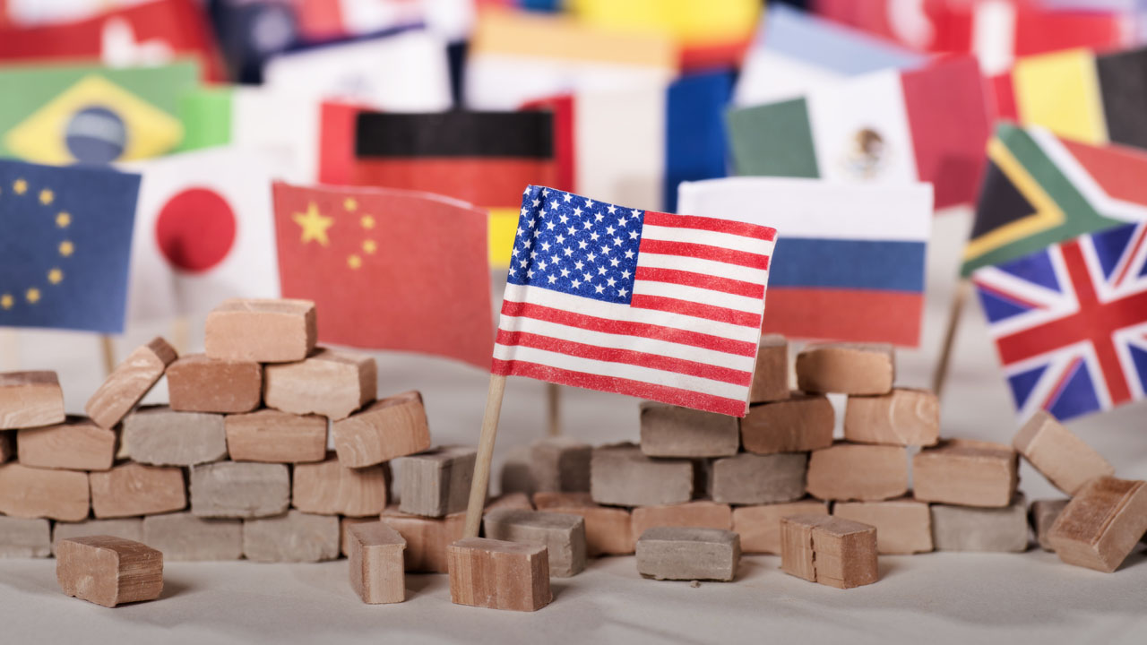 U.S. Flag separated by wall from other nations flags.