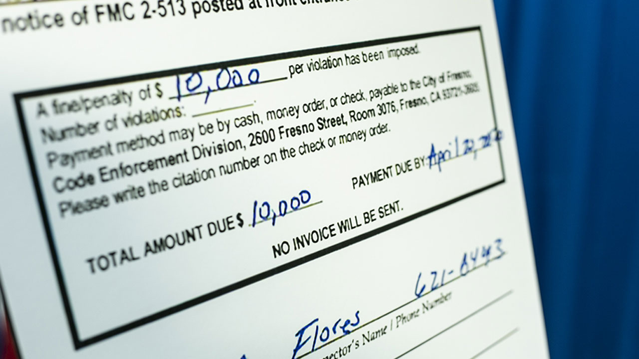 Enlargement of city of Fresno citation showing $10,000 fine issued to Super V Liquor for alleged price gouging.