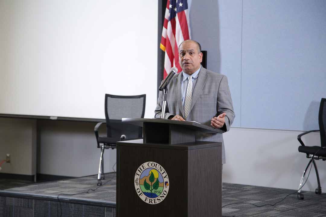 Photo of Dr. Rais Vohra speaking at a news conference