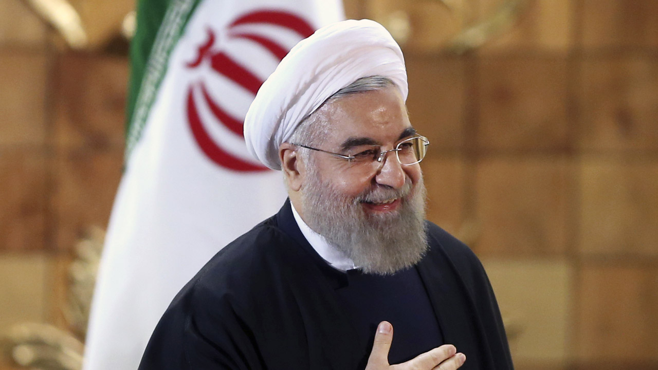 Iran President Hassan Rouhani in front of national flag