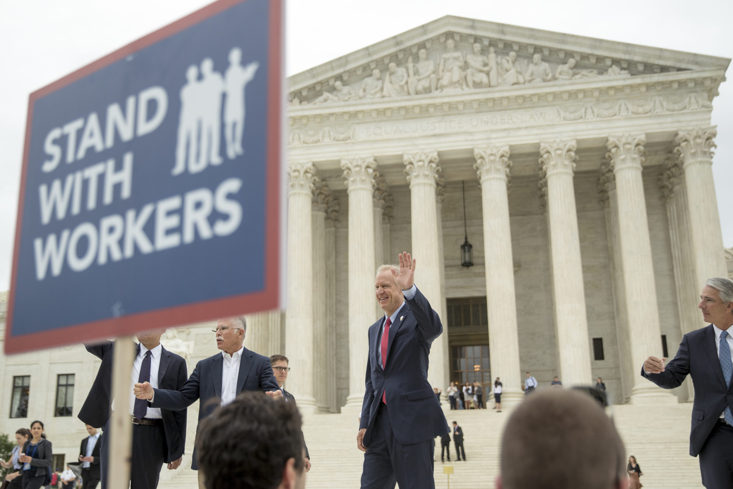 Photo of the victors in the Janus Case walking out of the U.S. Supreme Court building