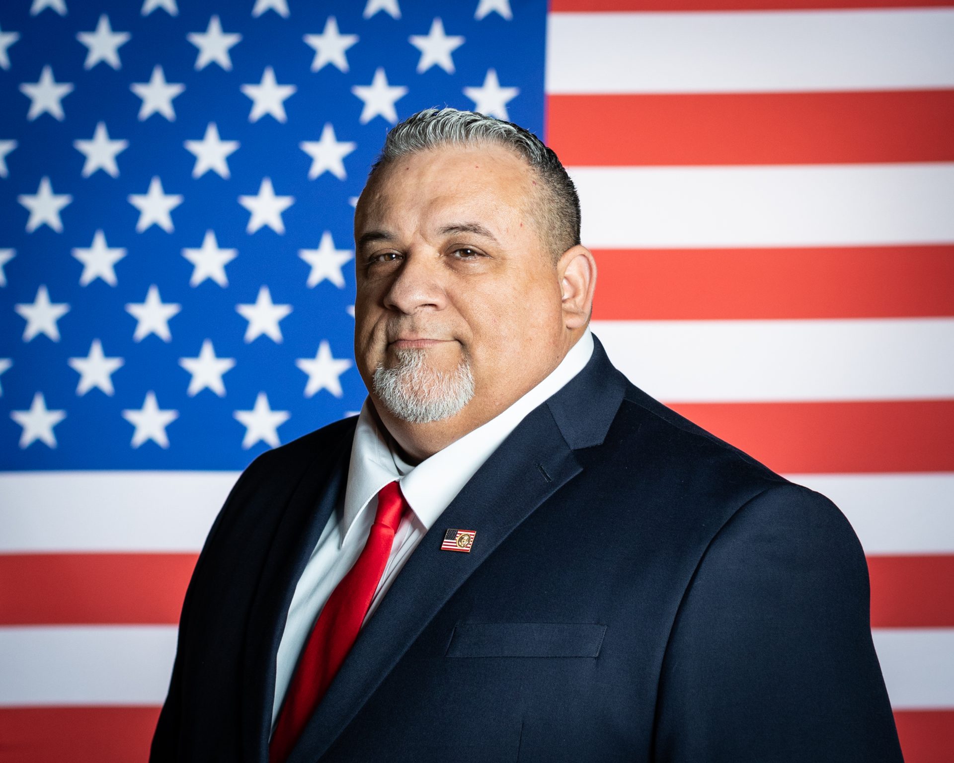 Photo of Jody Jones in front of an American Flaf