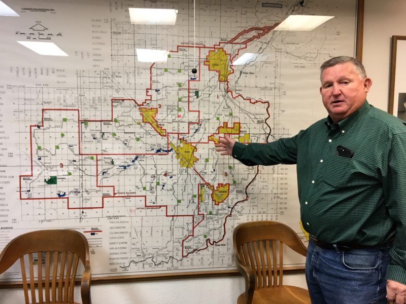 Photo of Phil Desatoff pointing to a map of water projects