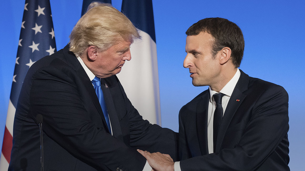 Image of President Donald Trump and French President Emmanuel Macron shaking hands.
