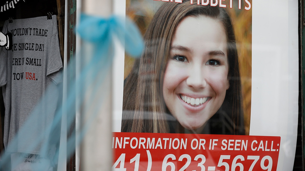 Photo of missing Mollie Tibbets poster hanging in a store window