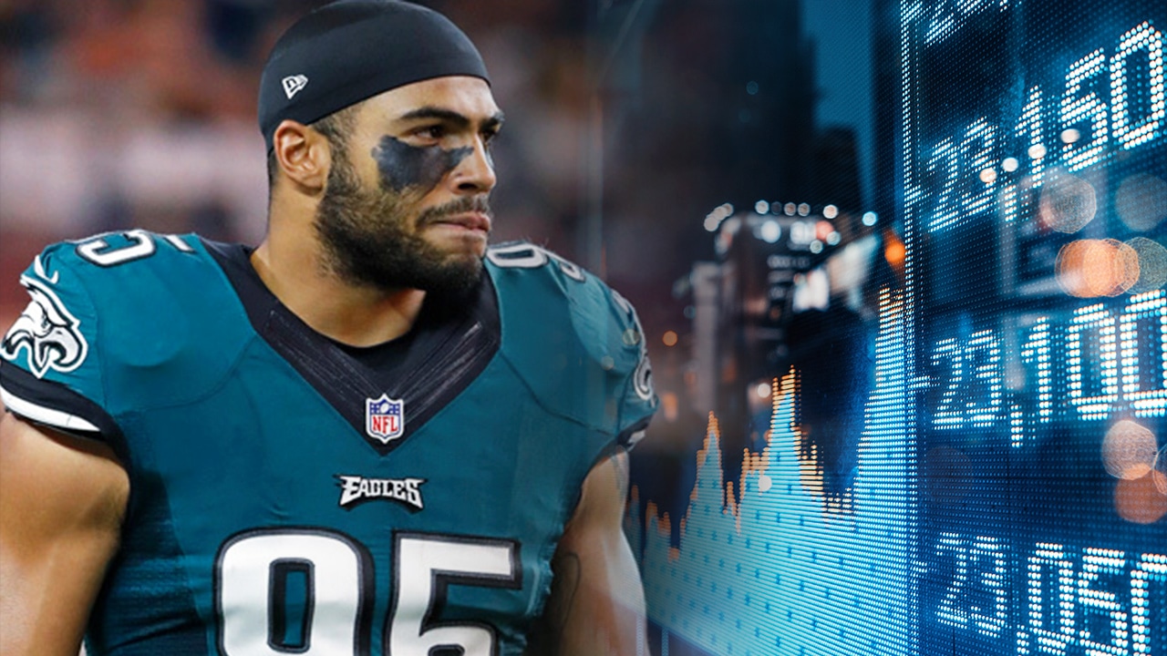 Photo of Mychal Kendrick and screen showing stocks