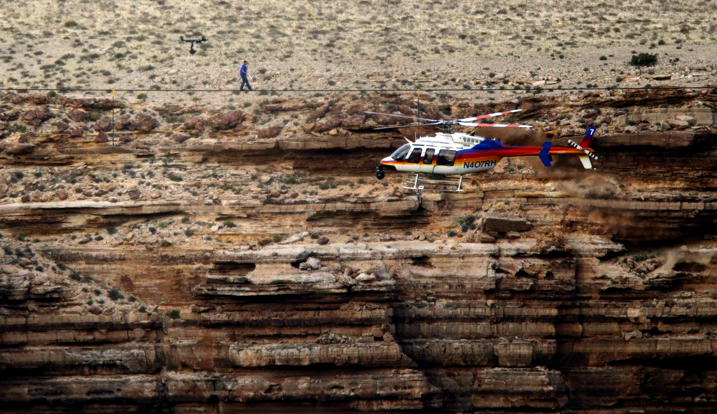 Photo of Nik Wallenda walking on a tightrope outside the Grand Canyon