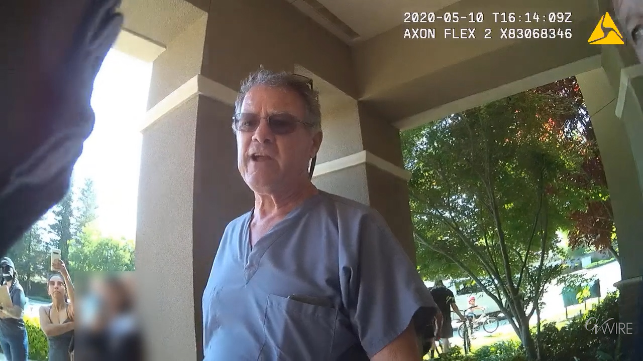 Photo of Tom Miller in handcuffs