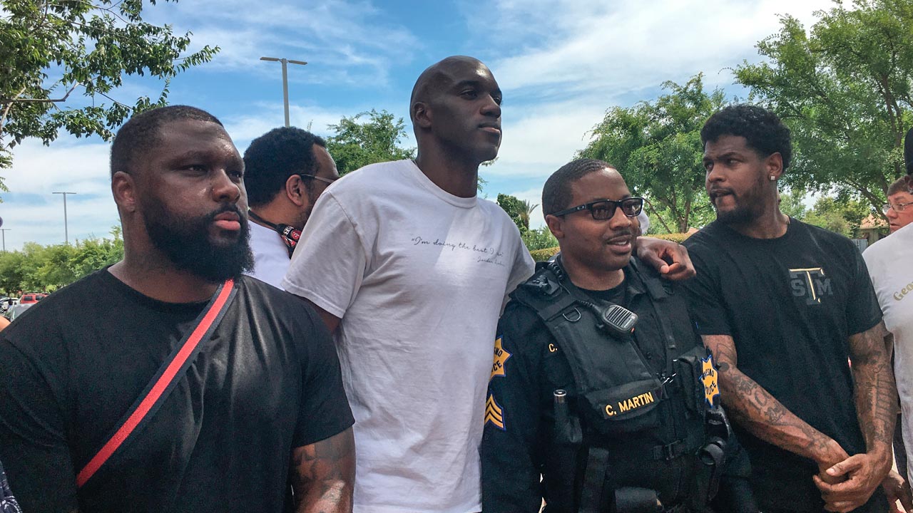Photo of Quincy Pondexter and other Fresno residents showing up at River Park to protect stores against a "riot" promoted on social media by sources that are now under investigation