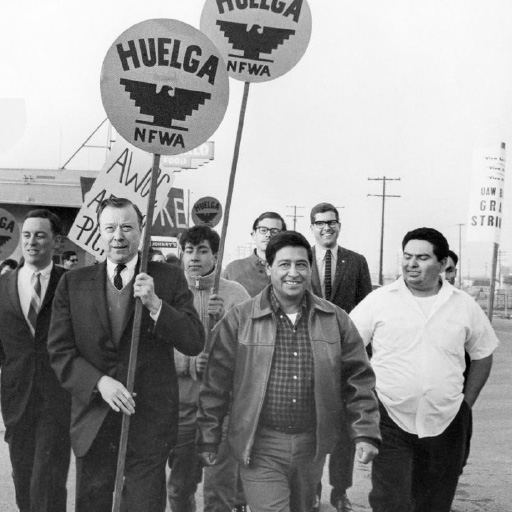 Photo of United Auto Workers President Walter Reuther carrying sign, along with Cesar Chavez, center, and Sal Gonzales Sr.