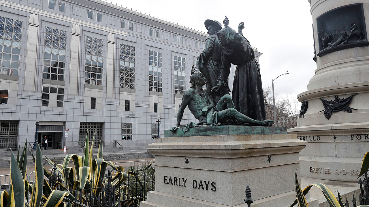 Photo of "Early Days" - a statue that depicts a Native American at the feet of a Spanish cowboy and Catholic missionary in San Francisco.