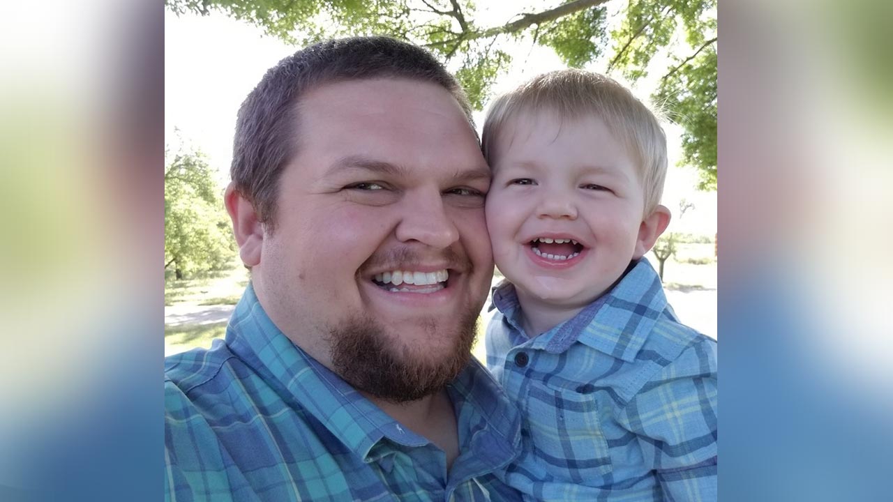 Photo of John Weir holding his son, Steven