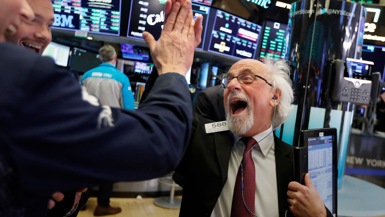 Photo of Wall Street floor traders exchanging high-fives