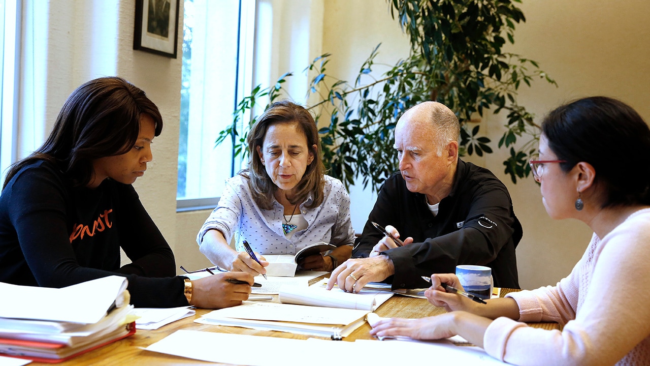 Photo of Gov. Jerry Brown reviewing a measure with his wife