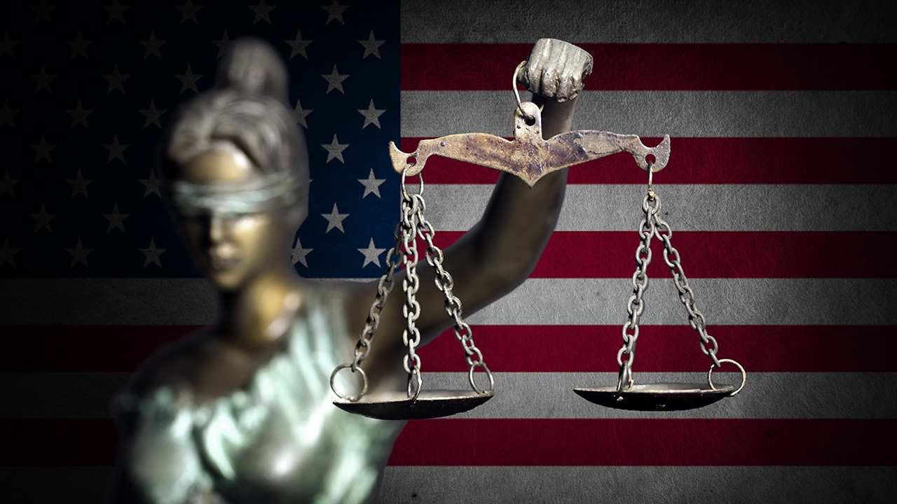 Photo of lady justice and flag background