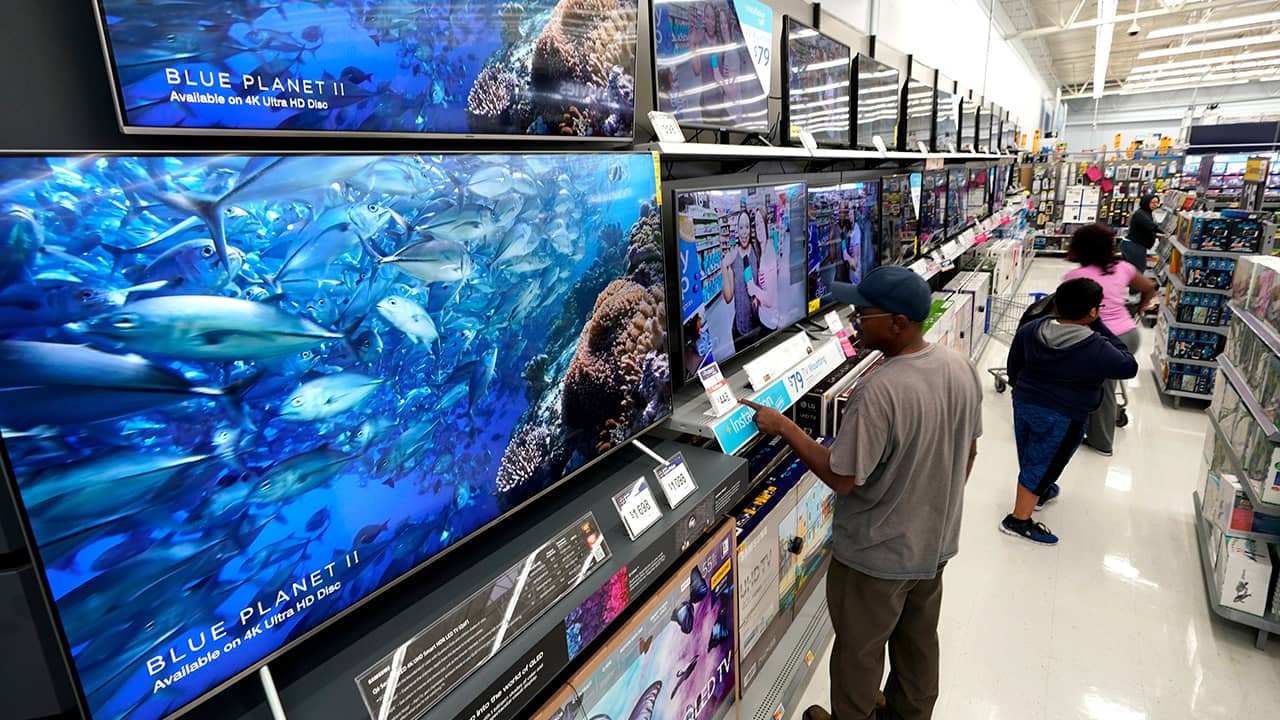 Photo of shoppers looking at televisions