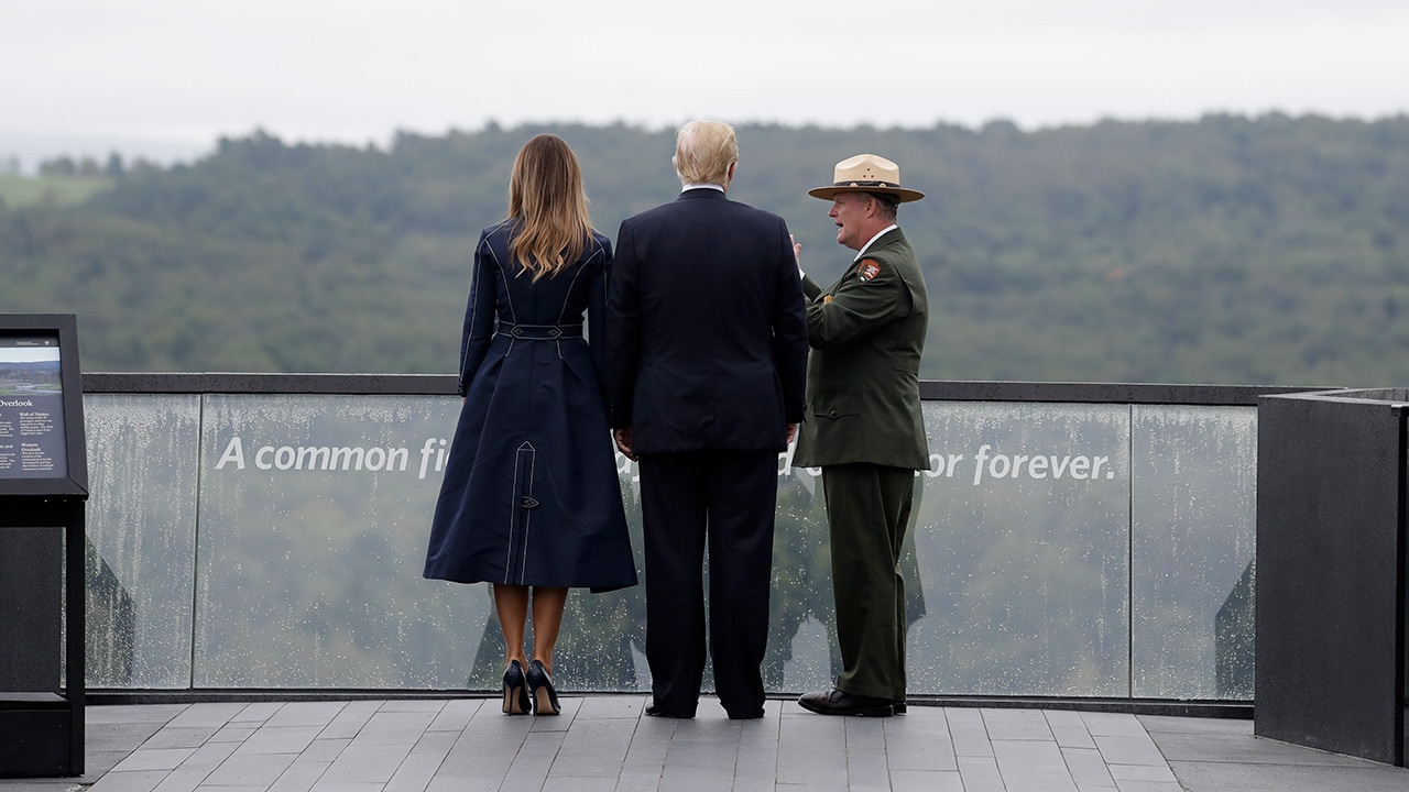 President Donald Trump and first lady Melania Trump walking along the September 11th Flight 93 memorial