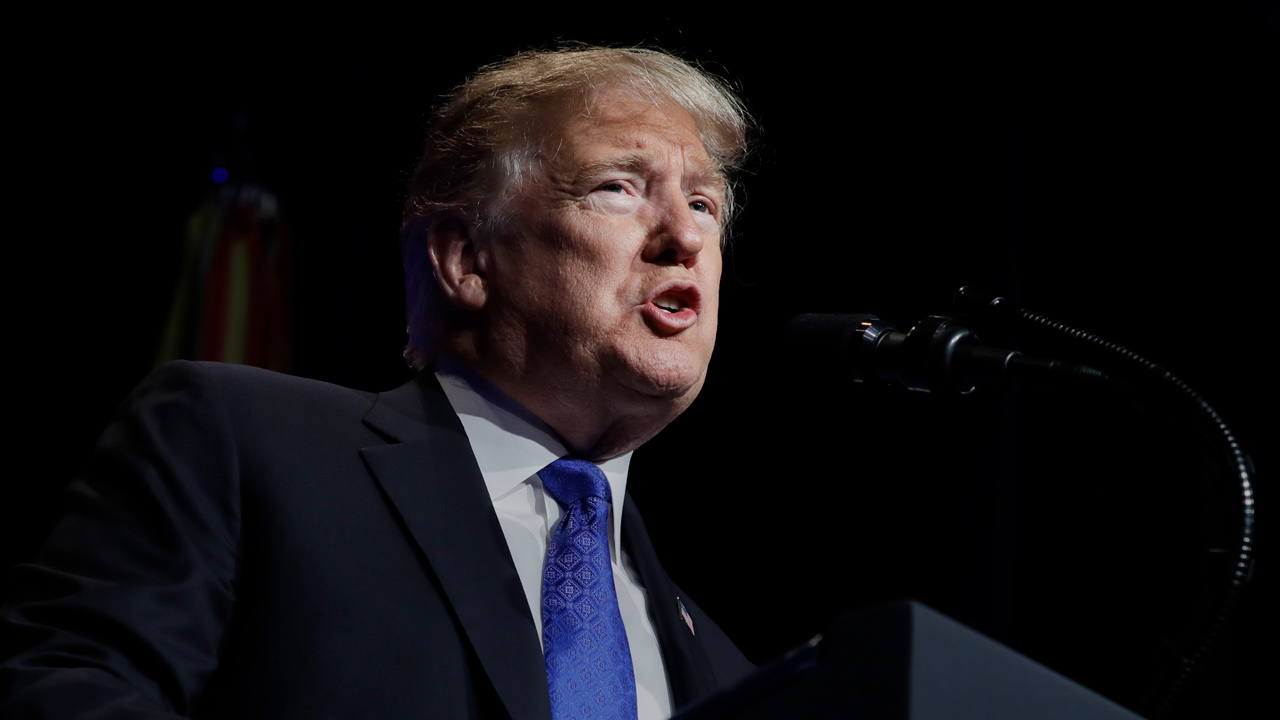 President Donald Trump speaks from podium.