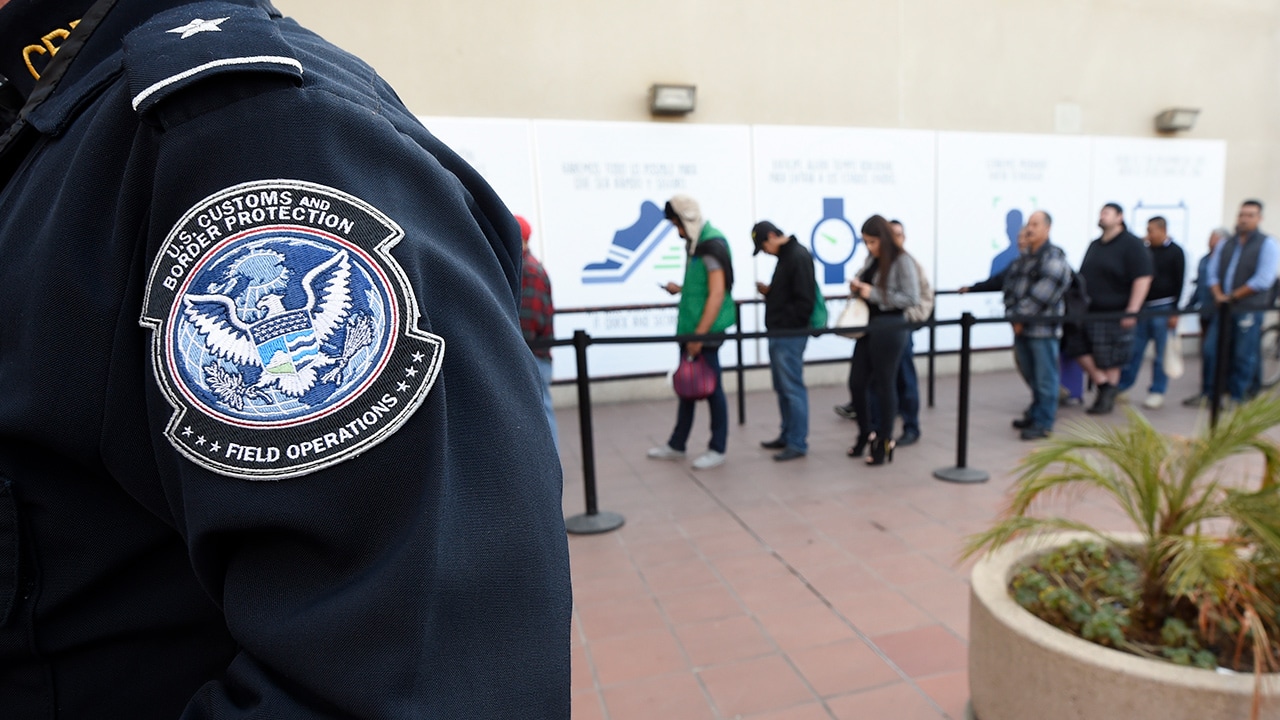 Photo of people crossing from Mexico into the U.S. in San Diego