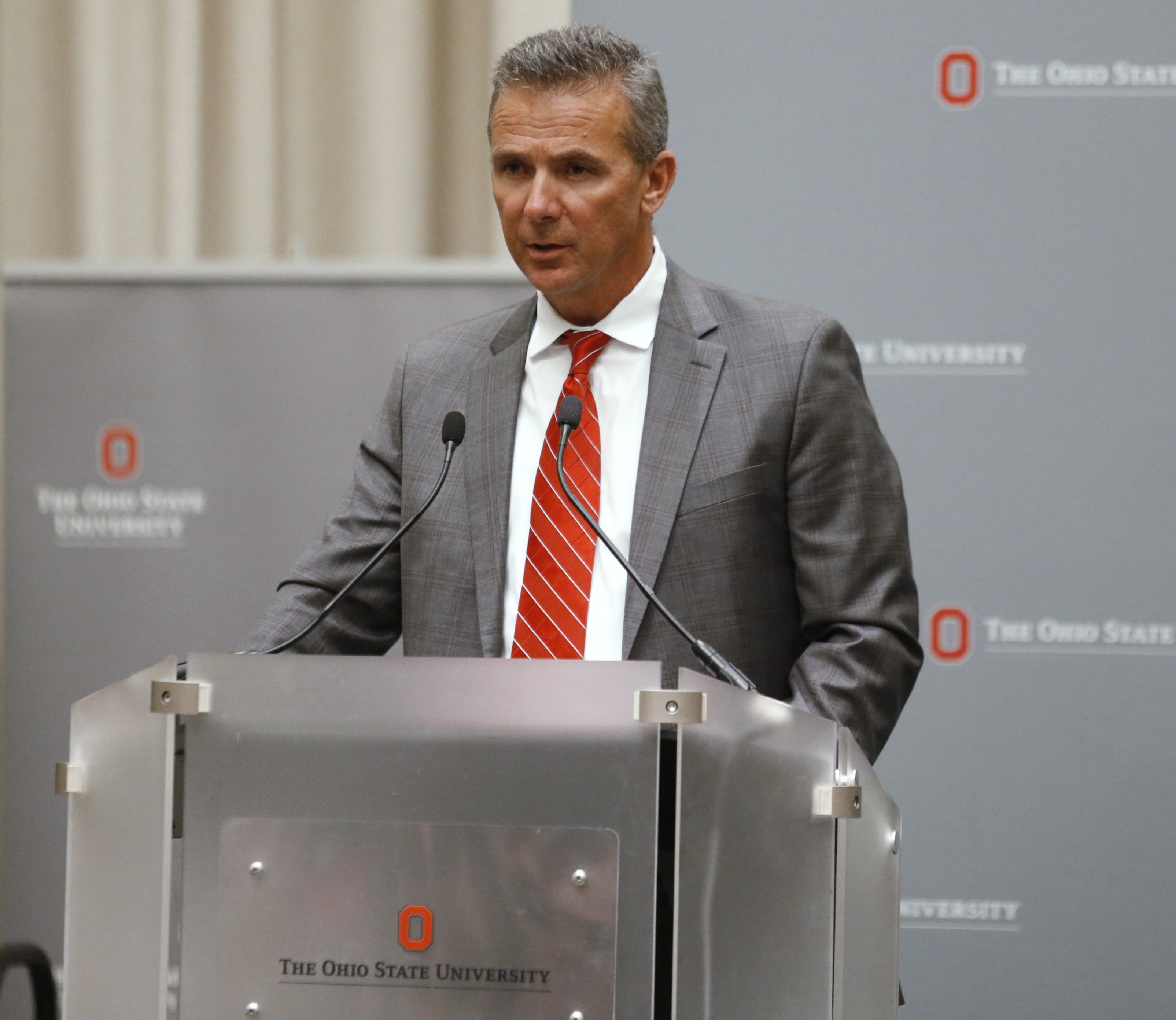 Photo of Urban Meyer making a statement during a news conference in Ohio